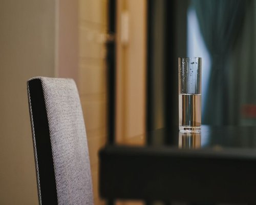 A glass of fresh water on a table in a home setting